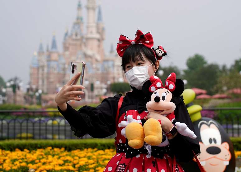 Visitante de parque da Disney tira selfie usando máscara de proteção. 11/5/2020. REUTERS/Aly Song     