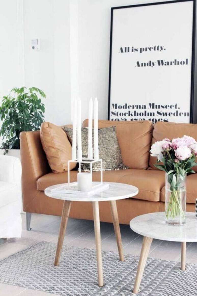 24. Quadros com frases grande para decoração de sala com mesa de mármore e sofá de couro marrom – Foto: Pinterest