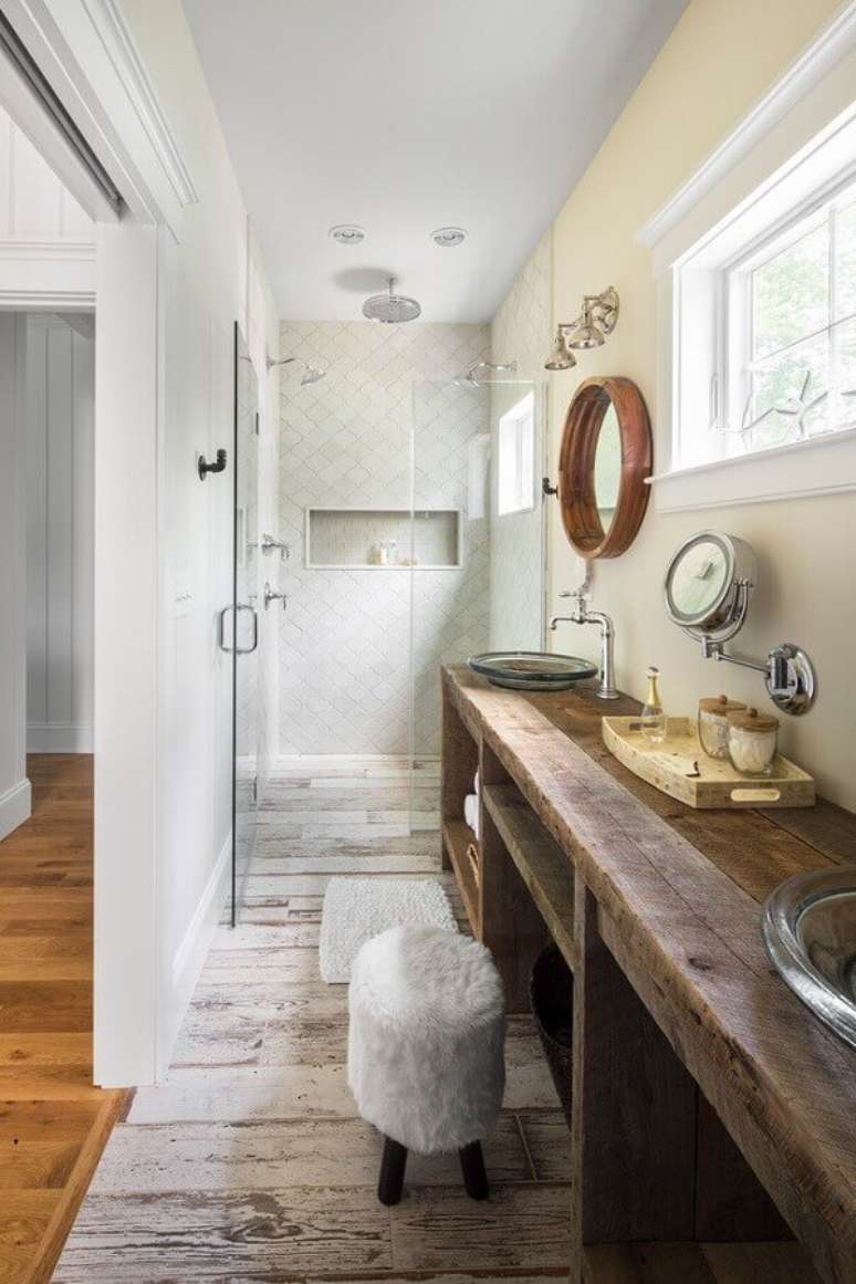 57. Pia de banheiro rústica decorada com cubas de vidro e bandeja de madeira – Foto: GMT Home Designs