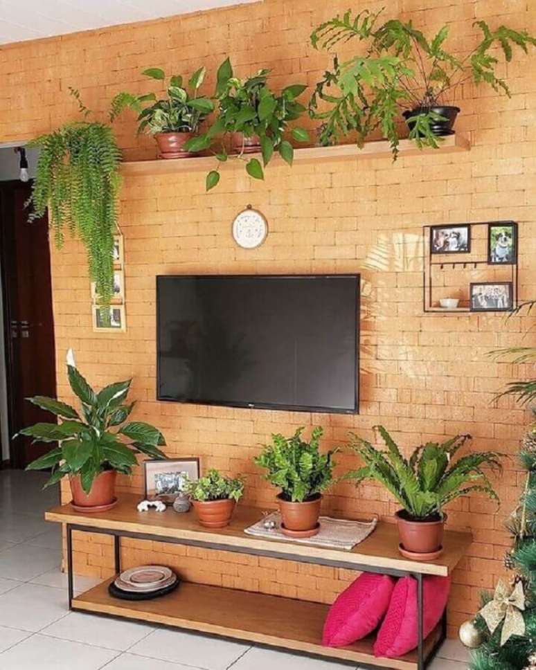 61. Sala de estar decorada com parede de tijolinho &agrave; vista e prateleira suspensa para plantas &ndash; Foto: Pinterest