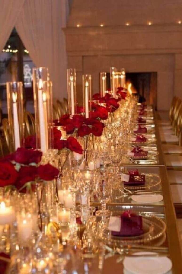 30. Decora&ccedil;&atilde;o sofisticada para bodas de cristal com arranjos de flores vermelhas e velas &ndash; Foto: Pinterest
