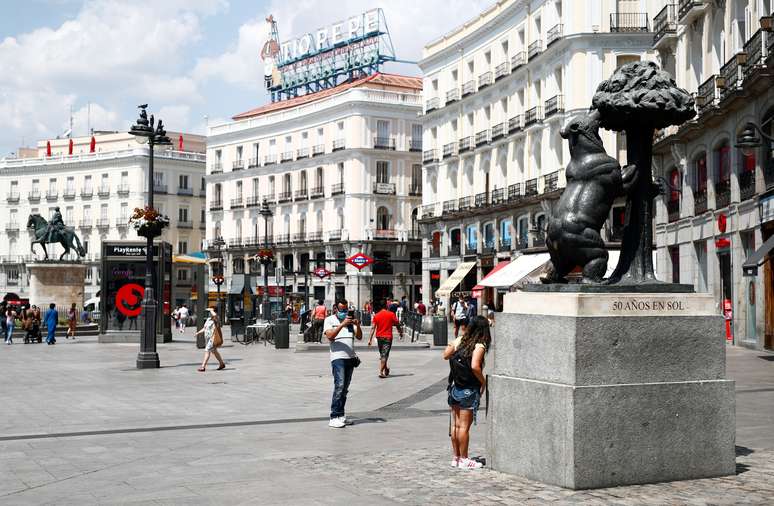 Mulher posa para foto ao lado de estátua na praça Puerta del Sol, em Madri
28/07/2020 REUTERS/Javier Barbancho