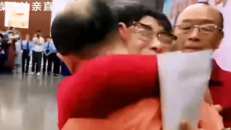 Abraço no momento em que Li Jingzhi viu seu filho pela primeira vez em 32 anos.