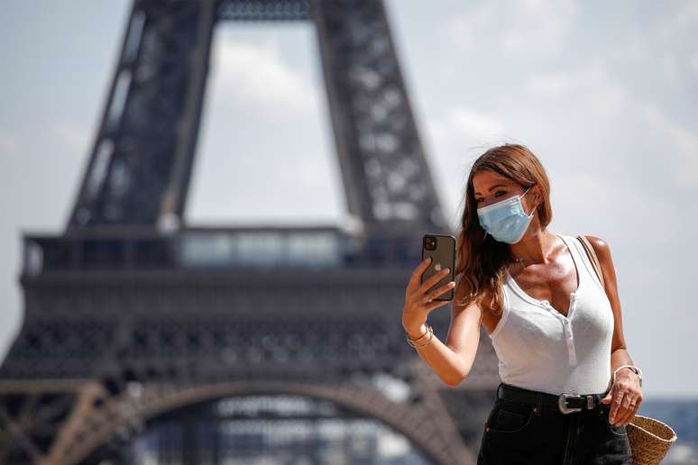 Mulher com m&aacute;scara tira foto em frente &agrave; Torre Eiffel
09/08/2020
REUTERS/Benoit Tessier