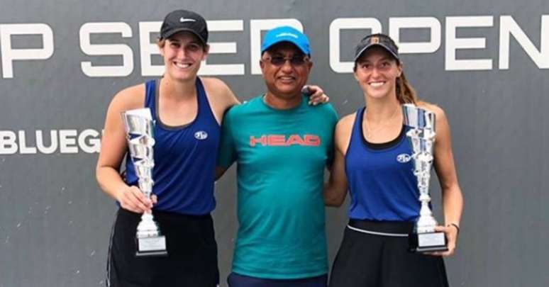 Luisa Stefani (à direita) posa com o troféu do torneio de Lexington junto com a parceira de dupla, Heyley Carter, e o treinador das duas, Sanjay