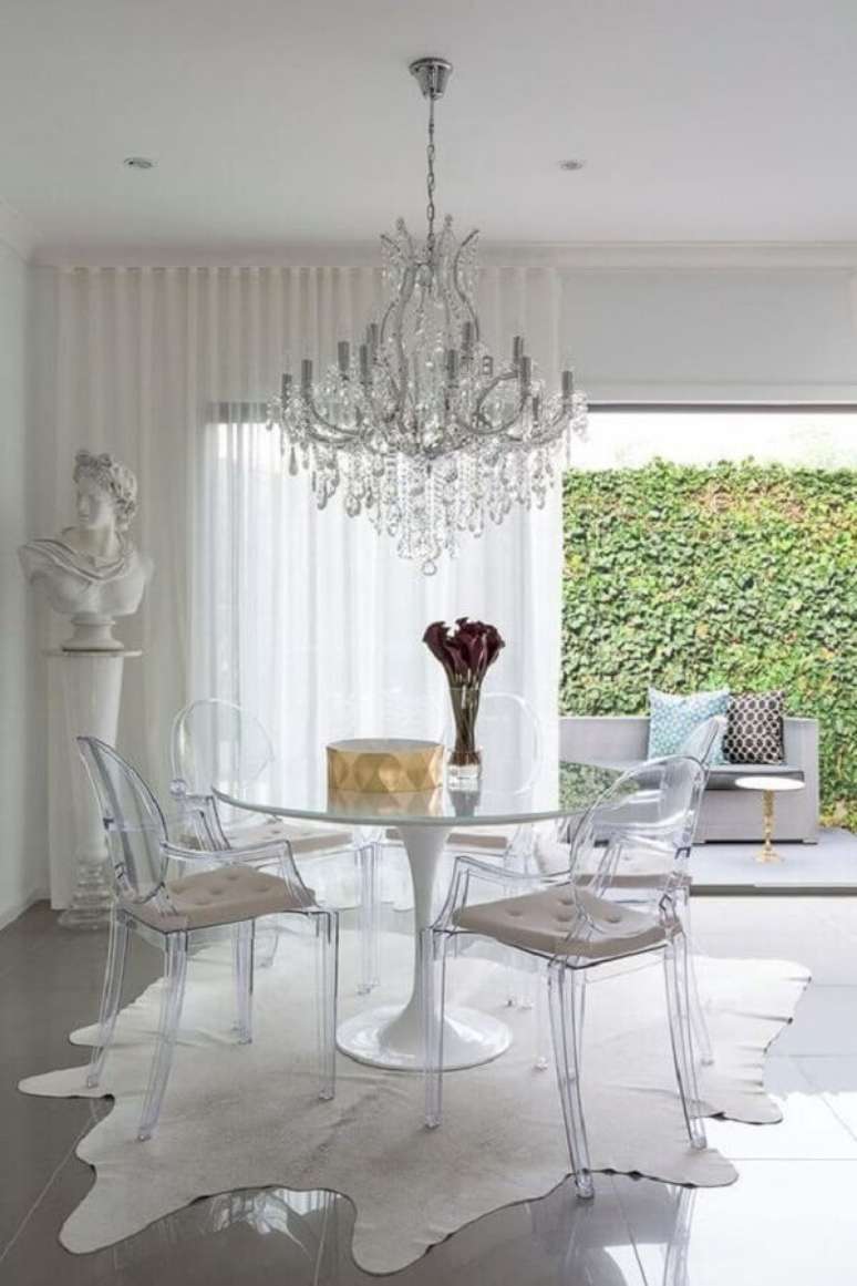 3. Mesa com cadeiras transparentes para sala de jantar sofisticada com lustre candelabro – Foto: Apartment Therapy