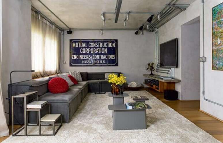 9. As almofadas vermelhas quebram a neutralidade do sofá de canto cinza. Fonte: Casa e Jardim