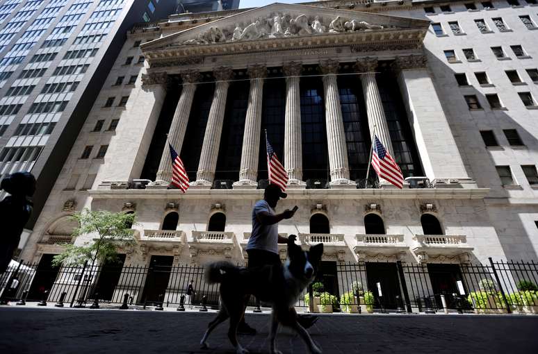 Homem passeia com cachorro em frente ao pr&eacute;dio da Bolsa de Valores de Nova York (NYSE) em Manhattan, 11 de agosto de 2020. REUTERS/Mike Segar