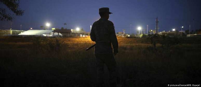 Policial militar perto da ponte de fronteira que cruza o rio Rio Grande, em Matamoros, México