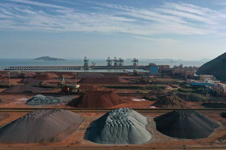 Piles of imported iron ore are seen at a port in Zhoushan, Zhejiang province, China May 9, 2019. Picture taken May 9, 2019. REUTERS/Stringer ATTENTION EDITORS - THIS IMAGE WAS PROVIDED BY A THIRD PARTY. CHINA OUT.