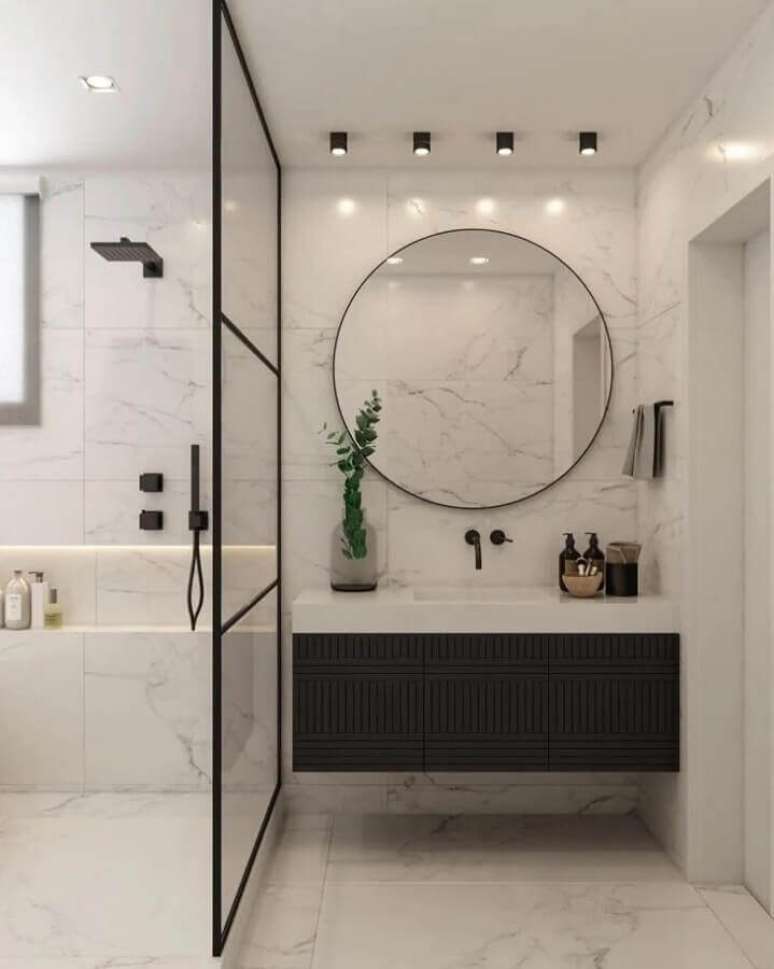 61. Espelho redondo para banheiro moderno preto e branco com gabinete suspenso – Foto: Carolina Druck