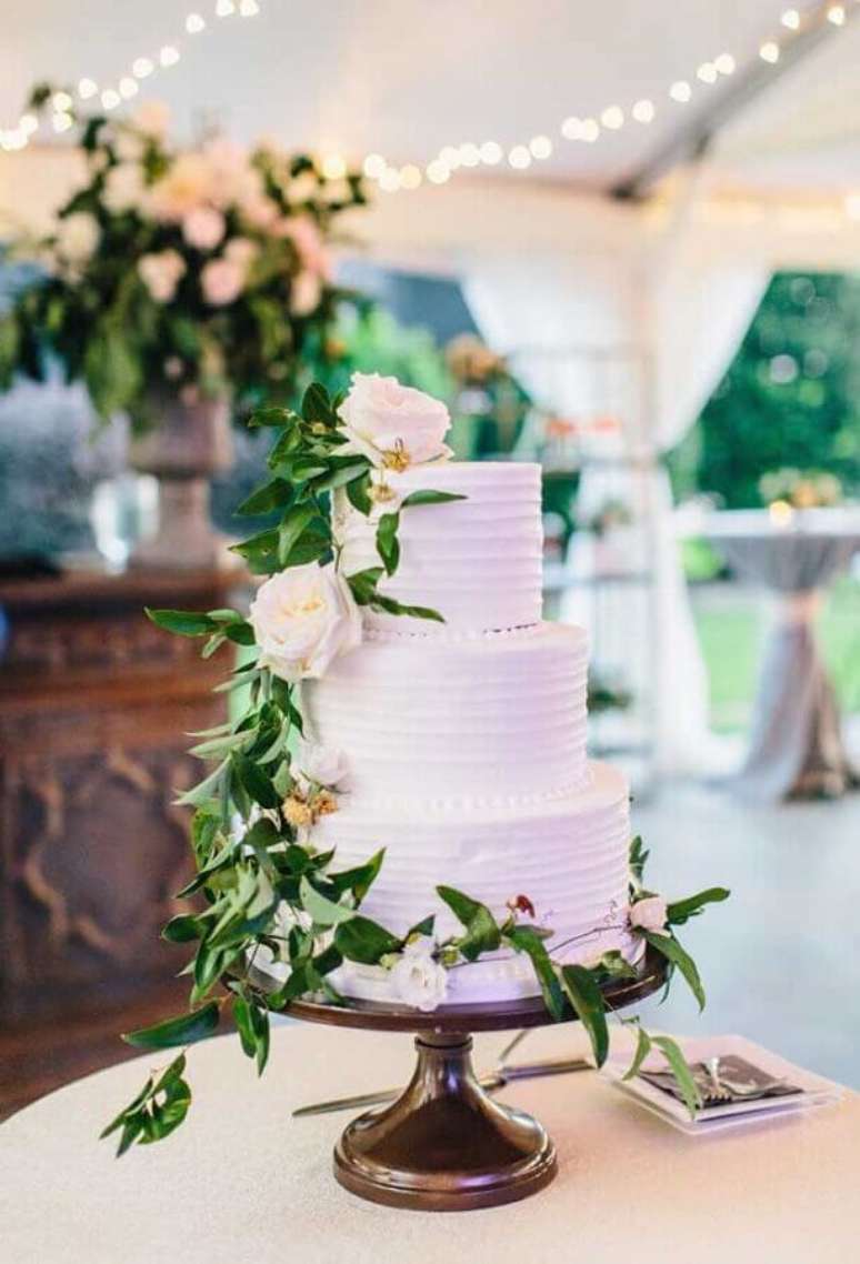 45. Lindo bolo decorado com rosas brancas e folhagens para decoração de mesa de casamento rústico – Foto: Pinterest