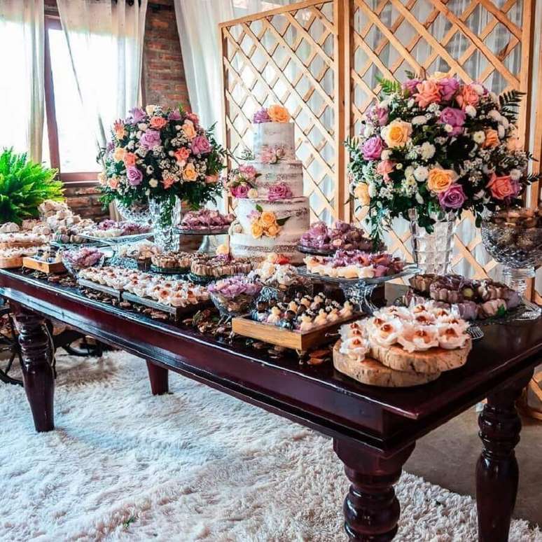 61. Linda decoração de mesa de casamento rústico com arranjos de rosas coloridas – Foto: Dona Filó Decorações