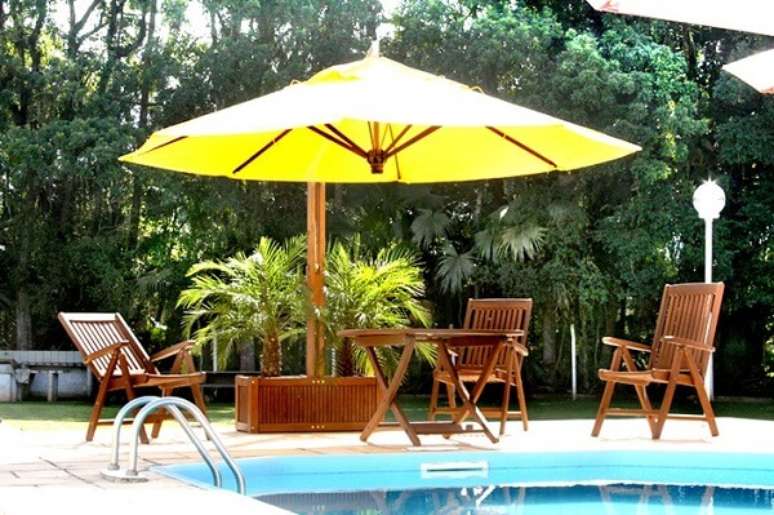 2. O ombrelone de madeira com floreira serve de apoio para o cultivo de flores artificiais e naturais. Fonte: Pinterest