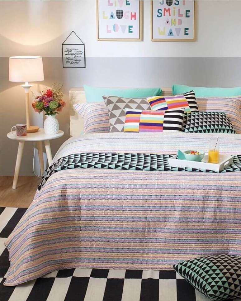 7. Decoração de quarto com almofadas coloridas e mesa de canto redonda retrô de madeira – Foto: Pinterest