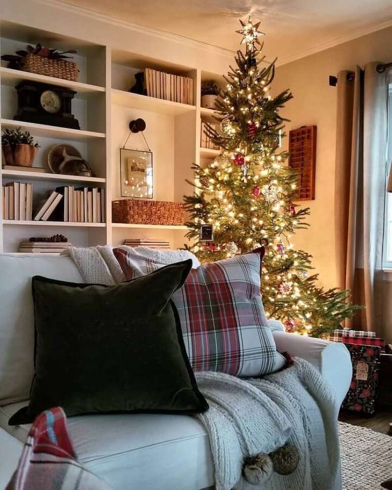 25. Ideias de decoração de Natal para sala com árvore de Natal grande e almofada xadrez – Foto: Rustic & Woven
