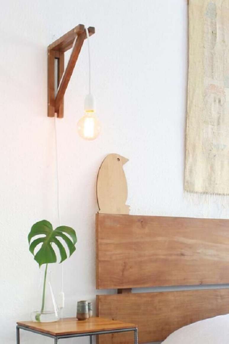 42. Quarto clean decorado com luminária de cabeceira de madeira – Foto: Boobam