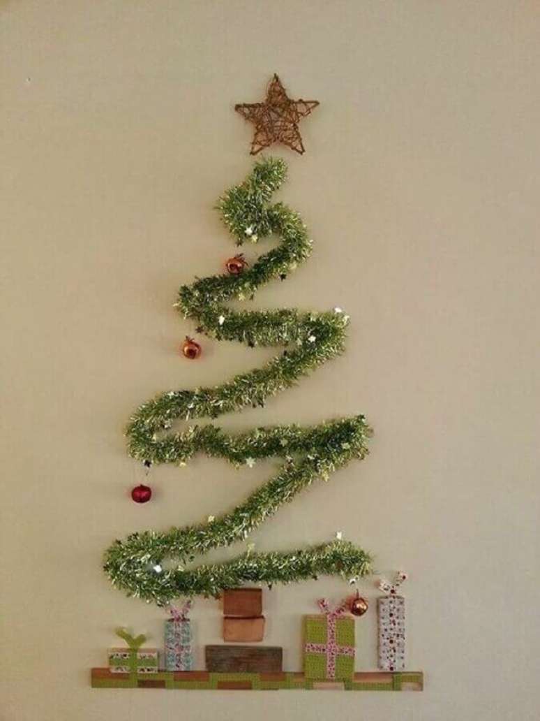 22. Decoração simples com árvore feita com festão de Natal na parede – Foto: Reciclar e Decorar