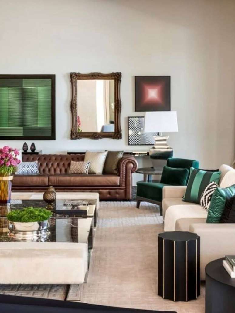 12. Decoração de sala ampla com sofá marrom chesterfield e poltronas brancas e verde – Foto: Maurício Karam