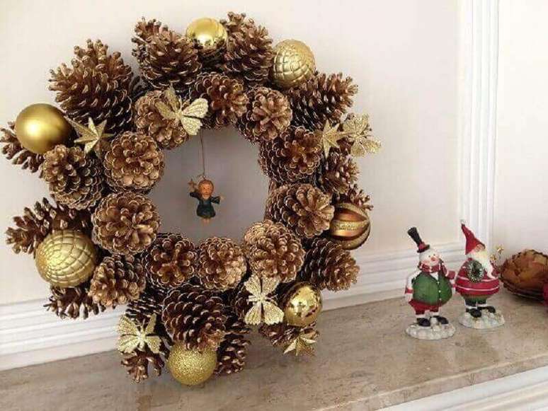 43. Modelo de guirlanda de Natal com pinhas e bolas douradas – Foto: Pinterest