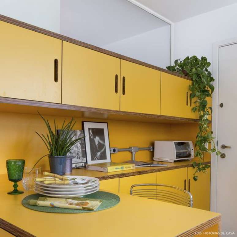 17. Armário de cozinha amarelo decorado com plantas – Via: Histórias de Casa