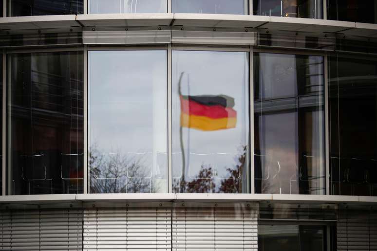 A German flag is reflected in the window of the Paul Loebe building, ahead of the arrival of Wirecard's former boss Markus Braun, in Berlin, Germany, November 19, 2020. REUTERS/Hannibal Hanschke  ?