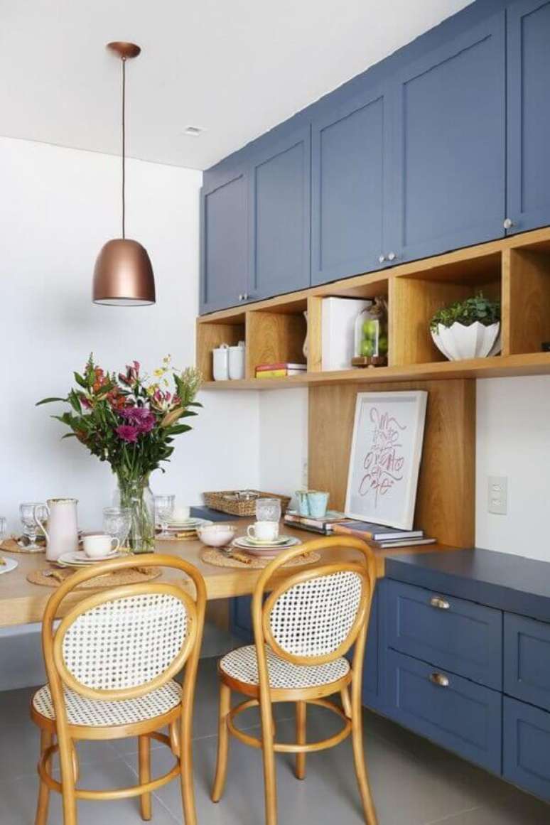 56. Decora&ccedil;&atilde;o retr&ocirc; com arm&aacute;rio de cozinha azul planejado com nichos de madeira &ndash; Foto: Casa de Valentina