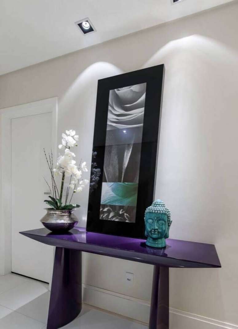 51. Decora&ccedil;&atilde;o simples para hall de entrada com espelho preto apoiado em aparador roxo &ndash; Foto: Pinterest