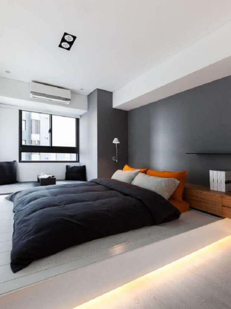 24. Tons de cinza com detalhe laranja para decoração de quarto masculino solteiro moderno – Foto: Futurist Architecture