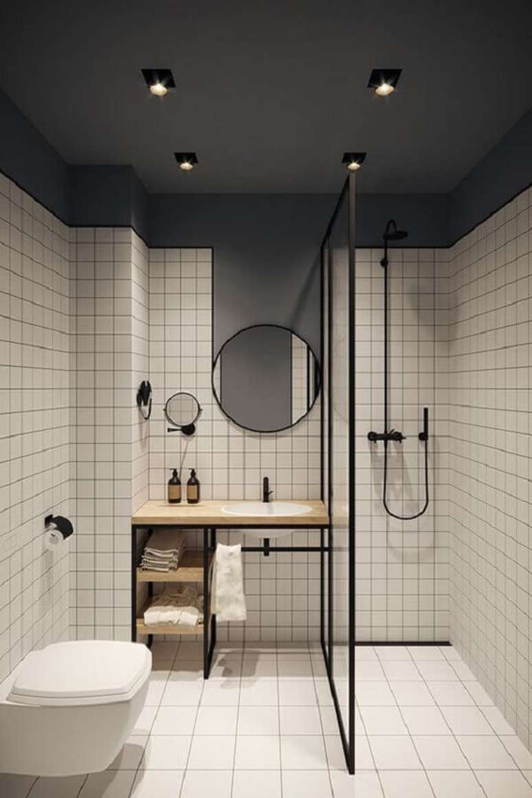 25. Revestimento quadriculado e espelho redondo para banheiro minimalista decorado – Foto: Jeito de Casa