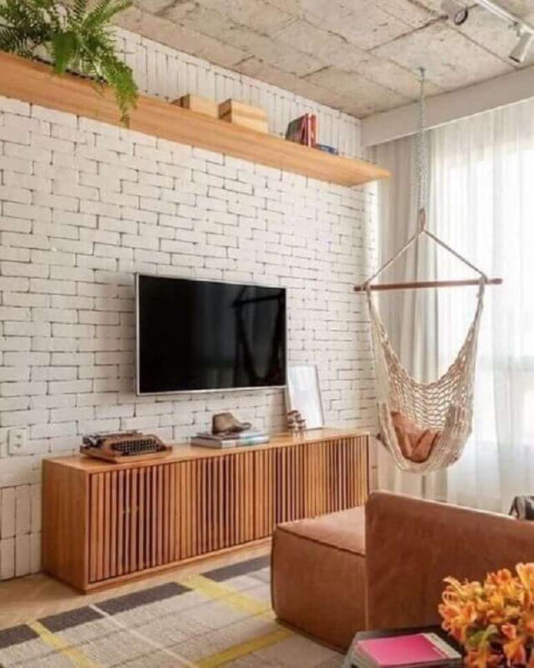 54. Decora&ccedil;&atilde;o de sala com tapete bege geom&eacute;trico com detalhes coloridos e parede de tijolinho branca &ndash; Foto: Iaza M&oacute;veis de Madeira