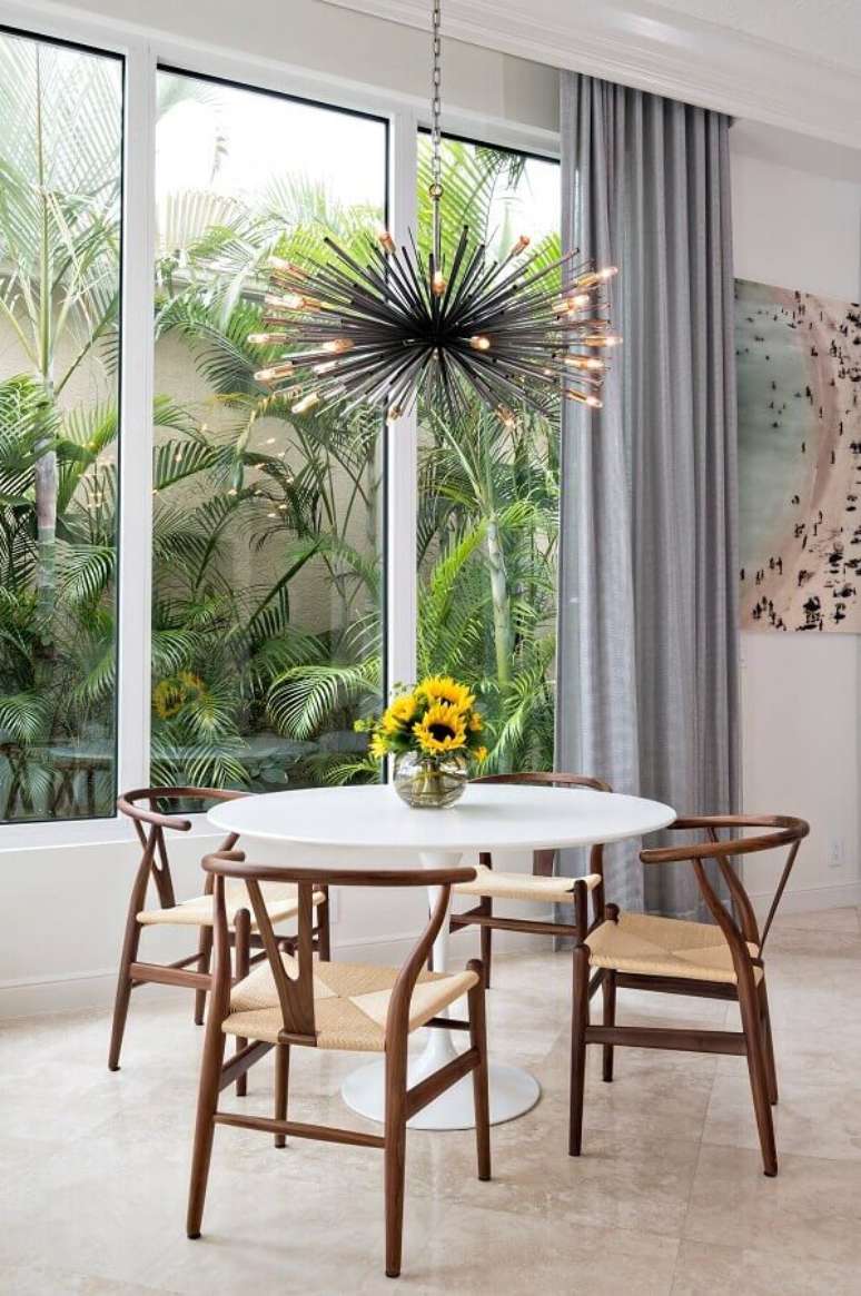 2. Lustre moderno e vaso de flores para decoração de sala de jantar com mesa redonda – Foto: Pinterest