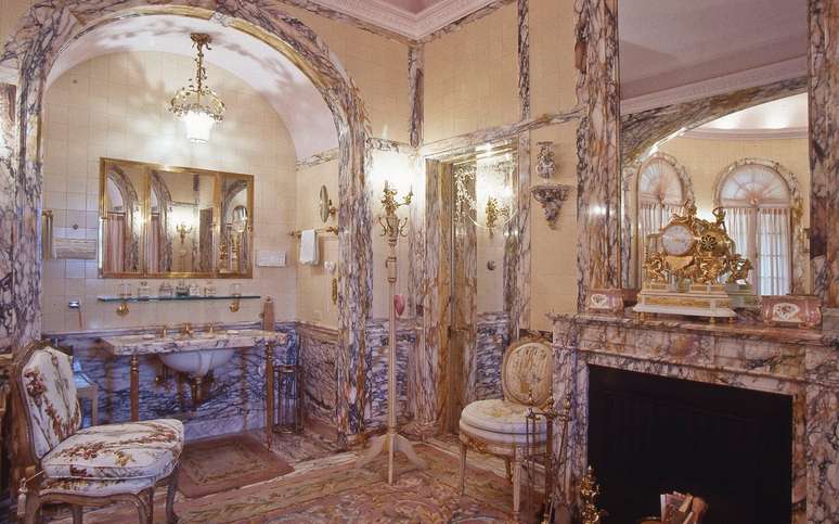 Os banheiros têm muito mármore, estampas e peças douradas