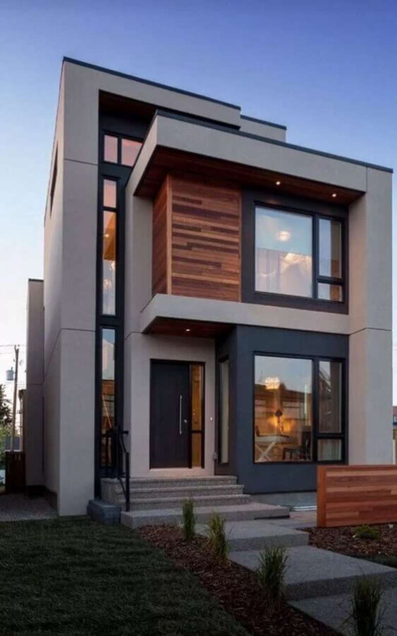 33. Arquitetura contemporânea para fachadas de casas em tons de cinza com detalhes em madeira – Foto: Pinterest