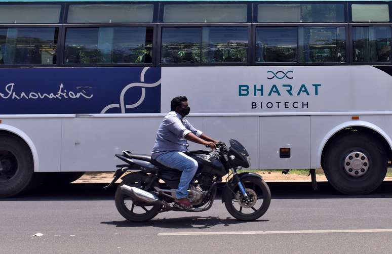 Homem passa de moto por &ocirc;nibus da empresa indiana Bharat Biotch em frente a sede da companhia em Hyderabad, na &Iacute;ndia 03/07/2020 REUTERS