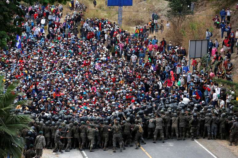 Hondurenho membors de uma caranava de imigrantes em direção aos Estados Unidos enfrentam soldados guatemaltecos, que tentam impedi-los de atravessar o território da Guatemala. 17/1/2021. REUTERS/Luis Echeverria