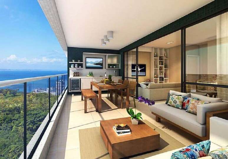 53. Sof&aacute; moderno sem bra&ccedil;o para decora&ccedil;&atilde;o de varanda de apartamento com mesa e cadeiras de madeira &ndash; Foto: LRV M&oacute;veis