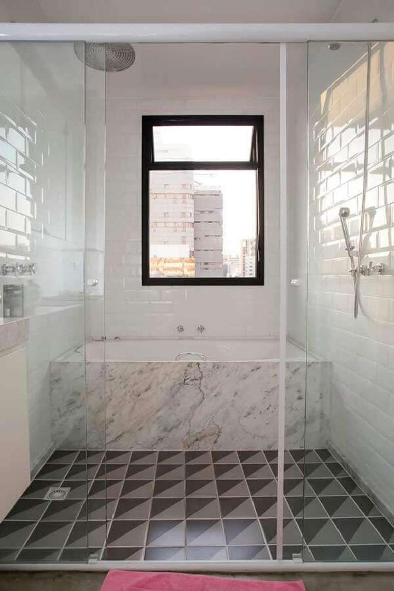 63. Azulejo de banheiro branco decorado com banheira de mármore e piso geométrico. Foto: Home Fashion Trend