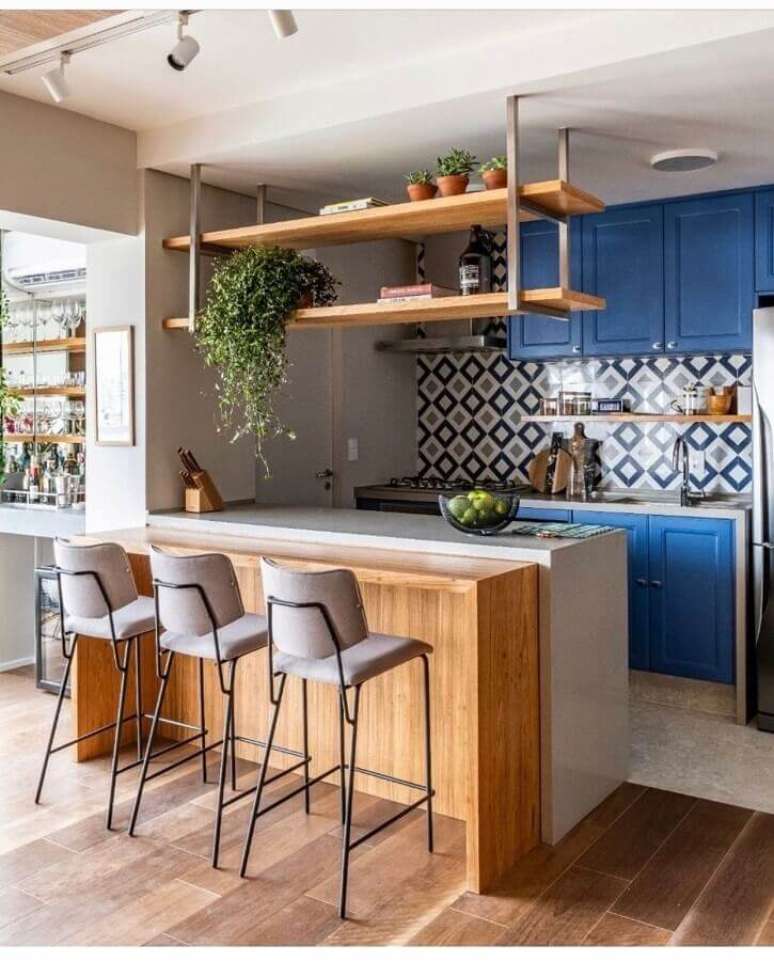 54. Banquetas para bancada de cozinha americana decorada com armários azuis. Foto: Pinterest