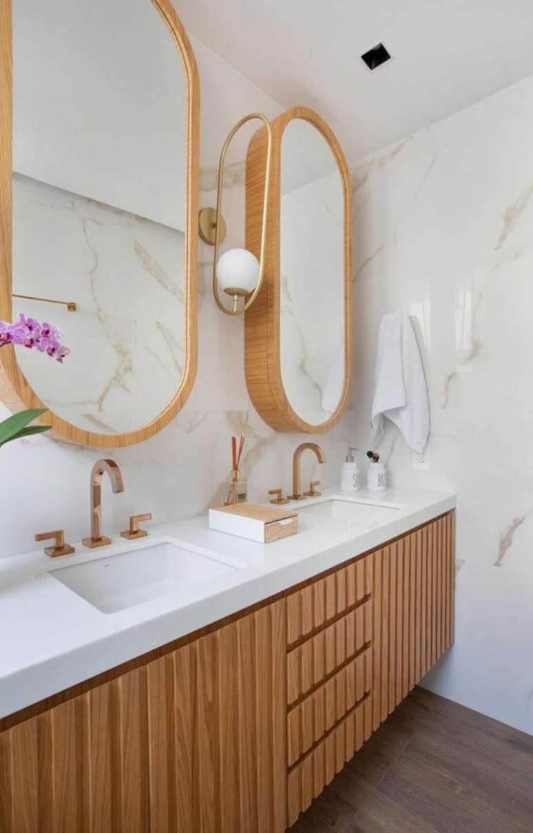 52. Banheiro com revestimento marmorizado e armários de madeira -Foto Casa de Valentina
