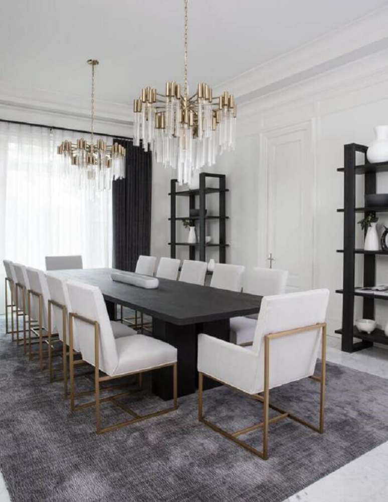 54. Mesa com cadeira acolchoada para sala de jantar sofisticada decorada com lustre moderno – Foto: Apartment Therapy