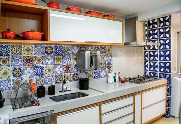 39. Cozinha com azulejos coloridos e armário basculante branco. Projeto por Caio José Andrade