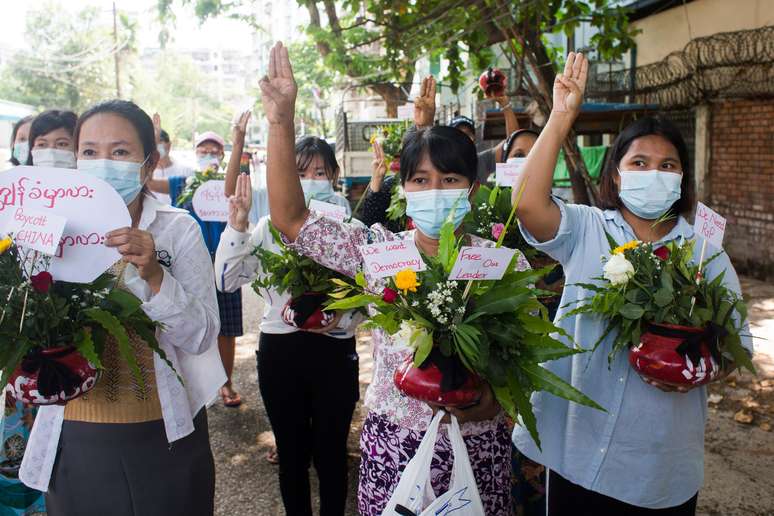 Mulheres carregam vasos de flores durante protesto contra golpe militar em Mianmar
13/04/2021 REUTERS/Stringer