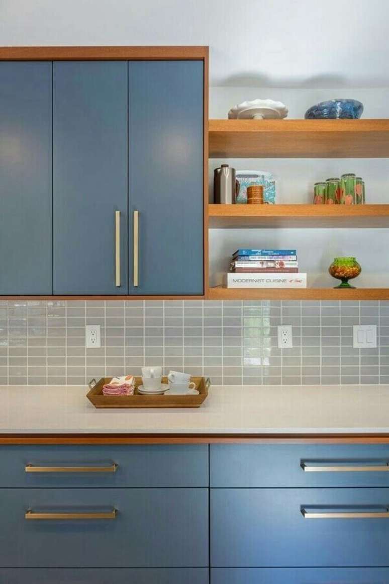 18. Decoração de cozinha azul com revestimento cinza claro e prateleiras de madeira – Foto: Pinterest