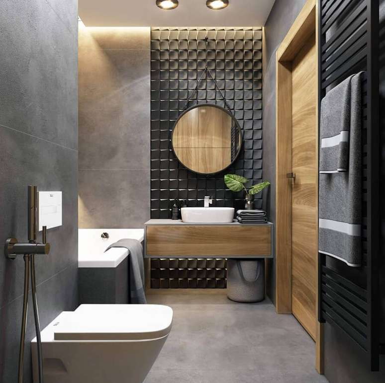 50. Revestimento cinza para banheiro moderno decorado com gabinete de madeira suspenso – Foto: JolyGram