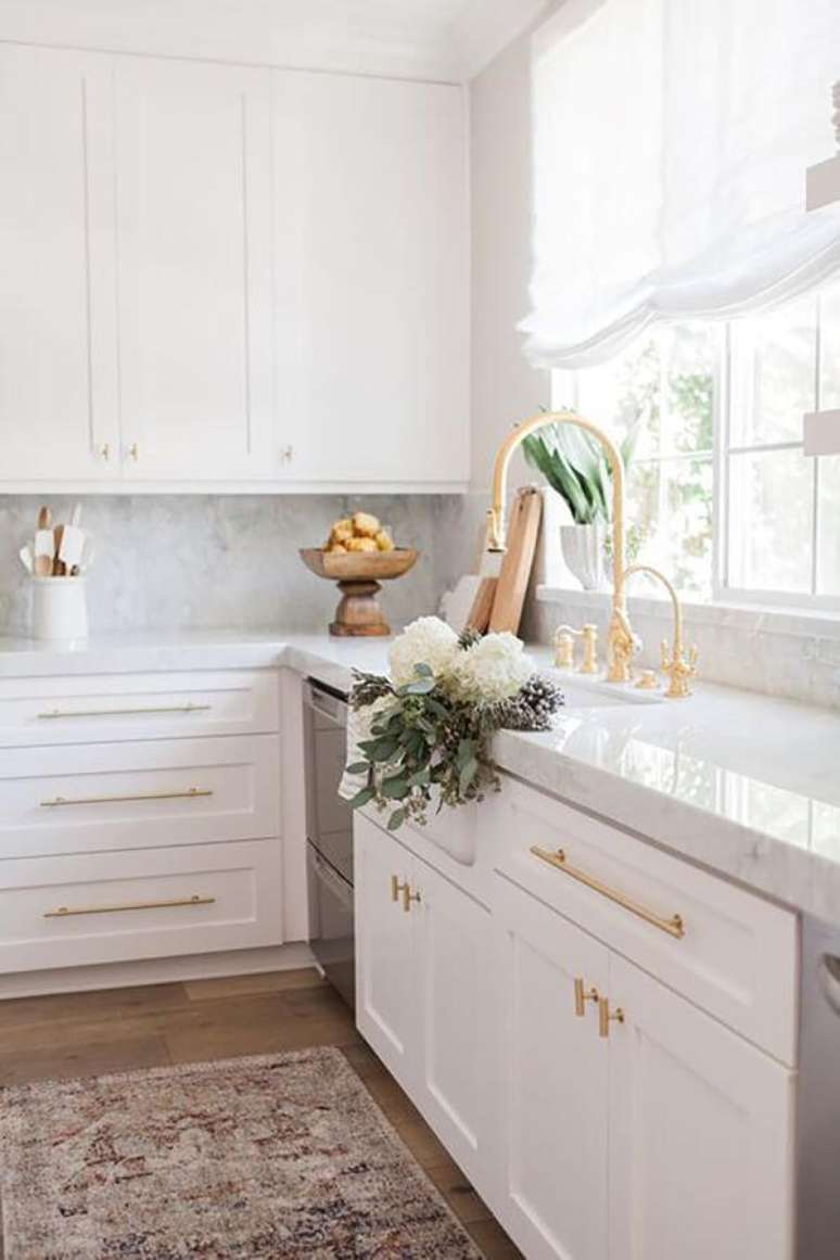 38. Bancada de cozinha branca com armários da mesma cor e torneira dourada gourmet – Foto Hurd and Honey