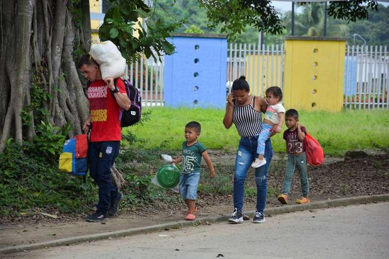 Migrantes venezuelanos caminham por rua de Arauquita, na Colômbia
05/04/2021
REUTERS/Stringer