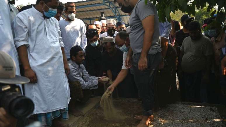 Pessoas em luto realizam funeral por Khin Maung Latt