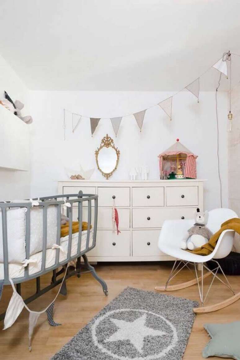 18. Cômoda para quarto de bebê decorado com berço cinza e cadeira de balanço – Foto: Houzz