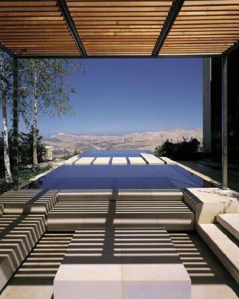 33, O contraste deste projeto está no uso das placas de concreto formando uma passagem na piscina grande. Fonte: Pinterest